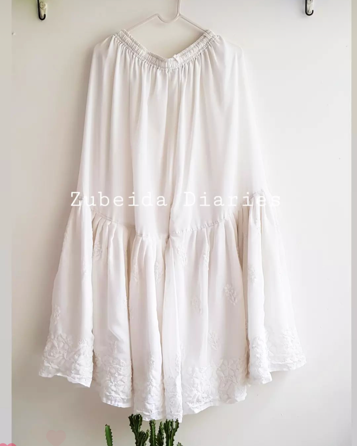 Georgette Sharara in Off-white